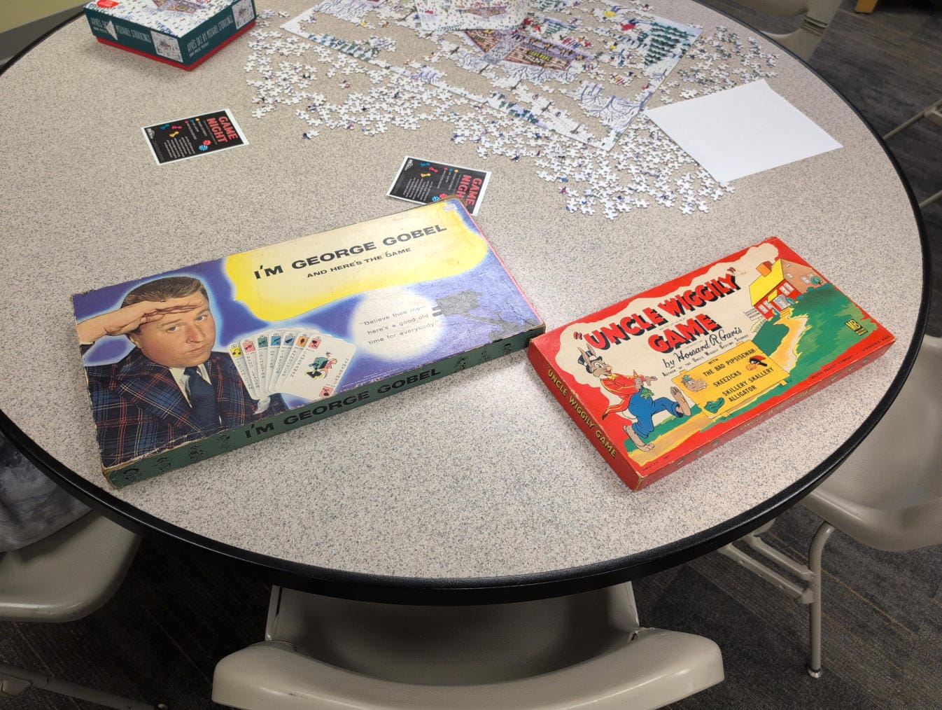 A table with two board games on it: I'm George Gobel and Uncle Wiggily Game.