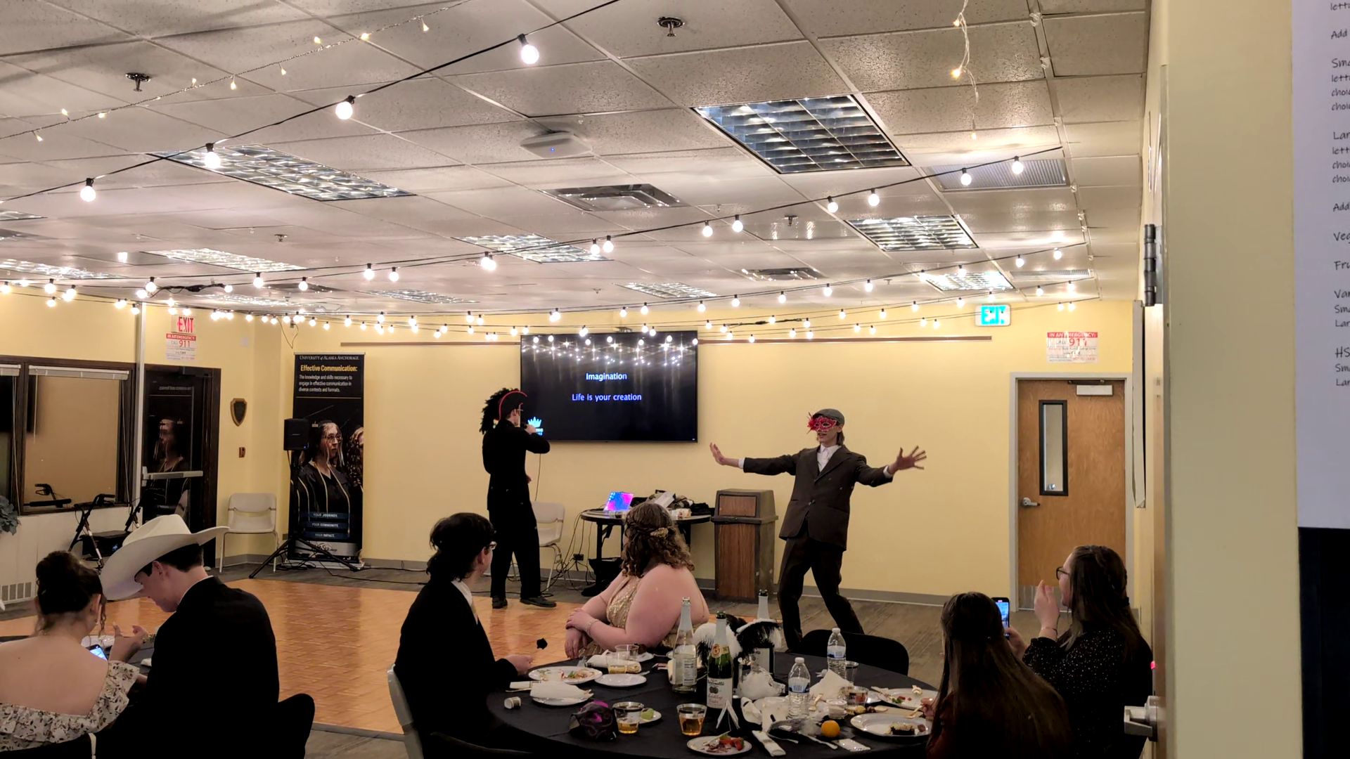 One student doing karaoke, another dancing.