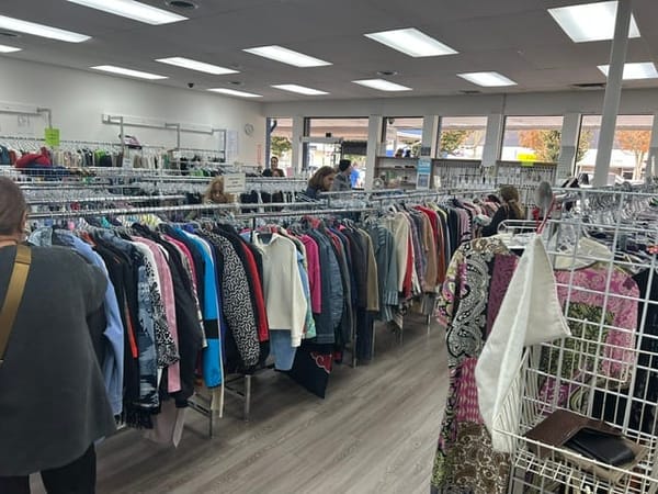Shoppers browse rows of second-hand clothing on racks inside the Delta Hospital Auxiliary Thrift Shop in Ladner Village.