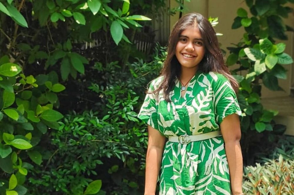 The poet enjoying her vacation in a field of greenery