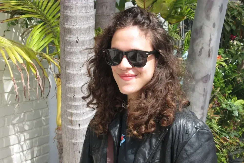 Portrait of Golda Grais wearing sunglasses and a leather jacket