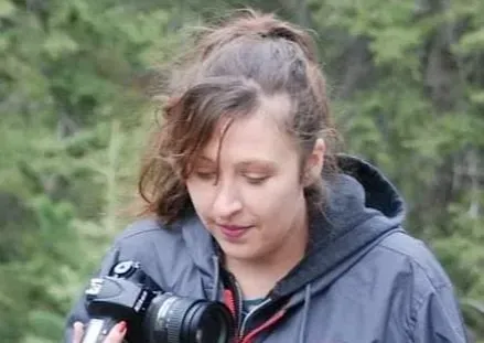 Candid snapshot of Deanna Faye looking at her camera.