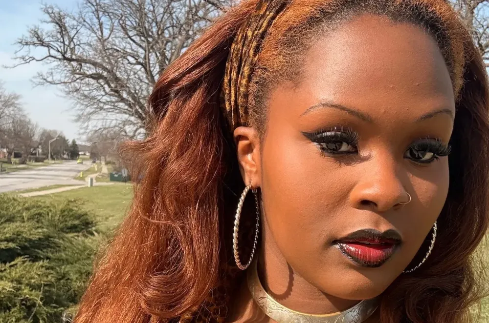 Seanice Lenay posed outside dressed in black.