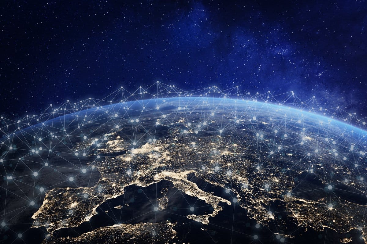 Night view of Earth from space showing Europe with city lights and a glowing network overlay.