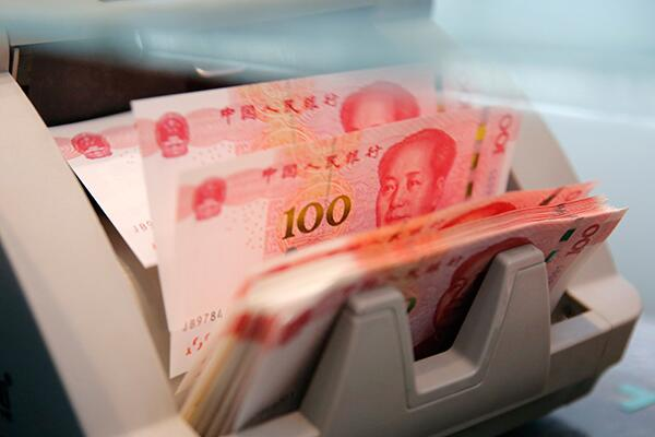 Chinese 100 yuan banknotes in a currency counting machine.