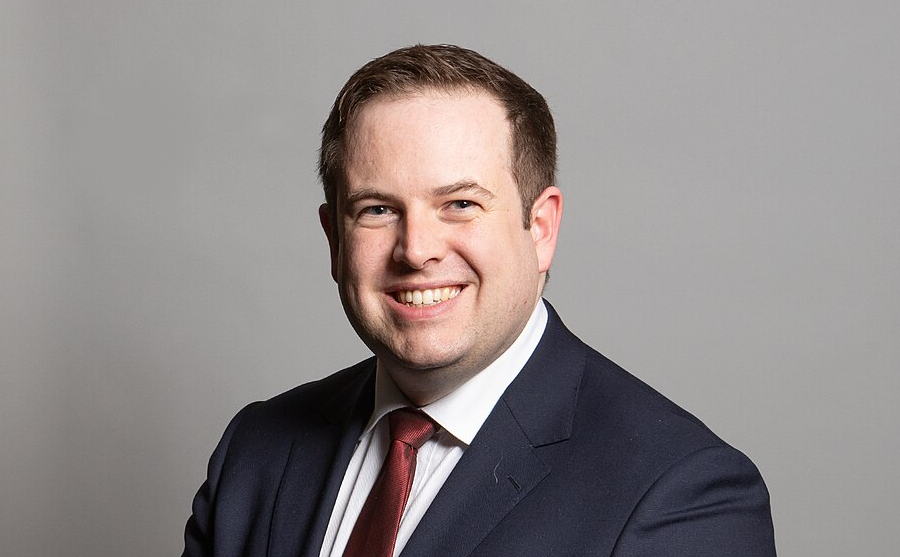 A smiling man in a blue suit