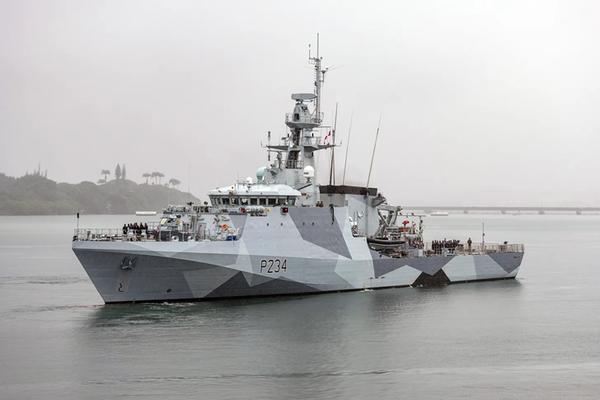 A warship with grey camouflage at sea